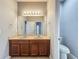 Bright bathroom featuring a double sink vanity, a large mirror, and neutral paint at 17146 Cypress Preserve Pkwy, Orlando, FL 32820