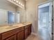 Bathroom features double sinks with dark brown cabinets, a large mirror and tile floors at 17146 Cypress Preserve Pkwy, Orlando, FL 32820