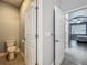 A partial bathroom leads to a bright bedroom with a view and tiled flooring at 17146 Cypress Preserve Pkwy, Orlando, FL 32820