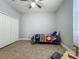 Bedroom featuring tile flooring, a ceiling fan, closet and bright window at 17146 Cypress Preserve Pkwy, Orlando, FL 32820