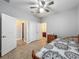 Bedroom featuring tile floors, ceiling fan and doors leading to other areas of the house at 17146 Cypress Preserve Pkwy, Orlando, FL 32820