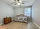 Neutral bedroom with tile floors, a window, a dresser, and patterned bedding at 17146 Cypress Preserve Pkwy, Orlando, FL 32820