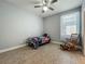Bedroom with tile flooring, ceiling fan, window view, and rocking chair at 17146 Cypress Preserve Pkwy, Orlando, FL 32820
