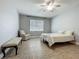 Neutral bedroom featuring light walls, ceiling fan, tile floors, window and sitting area at 17146 Cypress Preserve Pkwy, Orlando, FL 32820