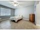 Bright bedroom with tile floors, a ceiling fan, a wood chest, and a decorative bedspread at 17146 Cypress Preserve Pkwy, Orlando, FL 32820