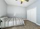 Cozy bedroom with neutral colors, tiled floors, ceiling fan and double door closet for ample storage at 17146 Cypress Preserve Pkwy, Orlando, FL 32820