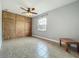 Bedroom features tiled floor, built in storage, ceiling fan, and a bright window at 17146 Cypress Preserve Pkwy, Orlando, FL 32820