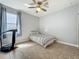 Bright bedroom with tiled flooring and a ceiling fan has a stationary cycle at 17146 Cypress Preserve Pkwy, Orlando, FL 32820