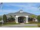 Community clubhouse with classic architectural design, clock tower, and manicured landscaping at 17146 Cypress Preserve Pkwy, Orlando, FL 32820