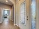 Home foyer featuring decorative glass front doors, archway to another room, and tile flooring at 17146 Cypress Preserve Pkwy, Orlando, FL 32820