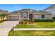 Charming single-story home with a well-maintained front yard, paver driveway, and attached two-car garage at 17146 Cypress Preserve Pkwy, Orlando, FL 32820