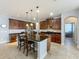 Spacious kitchen with a large island, dark wood cabinets, stainless steel appliances, and pendant lighting at 17146 Cypress Preserve Pkwy, Orlando, FL 32820
