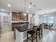Open concept kitchen with a center island, dark cabinets, stainless appliances, and a view to a breakfast nook at 17146 Cypress Preserve Pkwy, Orlando, FL 32820