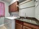 Functional laundry area with granite counters, sink, cabinets, and washer/dryer at 17146 Cypress Preserve Pkwy, Orlando, FL 32820