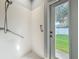 Accessible shower with grab bars and a view of the backyard at 17146 Cypress Preserve Pkwy, Orlando, FL 32820