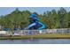 Community water park with a winding blue water slide near a lake at 17146 Cypress Preserve Pkwy, Orlando, FL 32820