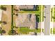 An overhead shot showcases the house's roof, landscaping, and location on the street at 1780 Southern Red Oak Ct, Ocoee, FL 34761