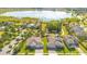 Aerial view of homes in a community with a community pool and a lake view at 1780 Southern Red Oak Ct, Ocoee, FL 34761
