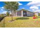 Spacious backyard with lush green lawn, a screened lanai, and secure black fence for privacy and play area at 1780 Southern Red Oak Ct, Ocoee, FL 34761