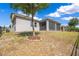 Expansive backyard with mature trees and manicured lawn, featuring a screened lanai for outdoor enjoyment at 1780 Southern Red Oak Ct, Ocoee, FL 34761