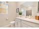 Bathroom showcasing a quartz counter, framed mirror, and tiled shower at 1780 Southern Red Oak Ct, Ocoee, FL 34761