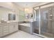 This bathroom features a tiled shower, tiled soaking tub, vanity, modern lighting fixture, and natural light at 1780 Southern Red Oak Ct, Ocoee, FL 34761