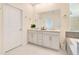 Bathroom with double vanity, marble counters, and gray tile accents at 1780 Southern Red Oak Ct, Ocoee, FL 34761