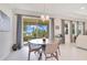 Bright dining area featuring modern chandelier, sliding glass doors, and view to the outdoor patio and lake at 1780 Southern Red Oak Ct, Ocoee, FL 34761