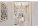 Bright foyer with tile flooring, contemporary lighting, and an open view of the living room at 1780 Southern Red Oak Ct, Ocoee, FL 34761