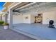 Spacious three-car garage with epoxy flooring, ample storage shelves, and bike racks for organization at 1780 Southern Red Oak Ct, Ocoee, FL 34761