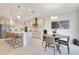 Open kitchen and dining area featuring stainless steel appliances, large island with seating, and modern lighting at 1780 Southern Red Oak Ct, Ocoee, FL 34761
