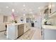 Open kitchen features stainless steel appliances, custom cabinets, and large center island at 1780 Southern Red Oak Ct, Ocoee, FL 34761