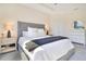 Bright main bedroom features a large bed with a tufted headboard and decorative lamps on the nightstands at 1780 Southern Red Oak Ct, Ocoee, FL 34761