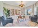 Inviting office space featuring built-in bookcases, stylish lighting, and comfortable seating near the bright window at 1780 Southern Red Oak Ct, Ocoee, FL 34761
