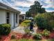 Relaxing back patio with seating, surrounded by lush landscaping, offering a serene outdoor escape at 17816 Se 115Th Ct, Summerfield, FL 34491