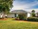 Well maintained backyard with healthy green grass, trimmed bushes and trees, with mulch surrounding bushes at 17816 Se 115Th Ct, Summerfield, FL 34491