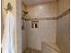 Elegant bathroom features custom tiled shower with built in seat and designer accents at 17816 Se 115Th Ct, Summerfield, FL 34491