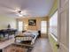 Cozy bedroom with two windows, ceiling fan, and tiled floor at 17816 Se 115Th Ct, Summerfield, FL 34491