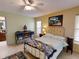 Cozy bedroom featuring a metal bed frame, dresser, and decor; light and bright at 17816 Se 115Th Ct, Summerfield, FL 34491