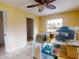 Bedroom features large window, closet, ceiling fan and tile flooring at 17816 Se 115Th Ct, Summerfield, FL 34491
