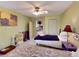 Spacious bedroom with two twin beds, ceiling fan, and tile flooring at 17816 Se 115Th Ct, Summerfield, FL 34491