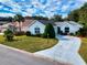 Charming single-story home with a well-manicured lawn and a long driveway at 17816 Se 115Th Ct, Summerfield, FL 34491