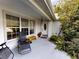 Inviting front porch with seating and landscaping, leading to a charming front door at 17816 Se 115Th Ct, Summerfield, FL 34491