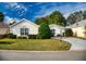 Charming home featuring a manicured lawn, mature trees, and neat landscaping at 17816 Se 115Th Ct, Summerfield, FL 34491