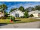 Charming home with lush lawn, mature trees, and well-maintained landscaping create a welcoming curb appeal at 17816 Se 115Th Ct, Summerfield, FL 34491