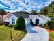 Charming single-story home featuring a well-manicured lawn, elegant landscaping, and a private driveway at 17816 Se 115Th Ct, Summerfield, FL 34491