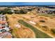 Picturesque golf course view showcasing manicured greens, sand traps, and distant residential community at 17816 Se 115Th Ct, Summerfield, FL 34491