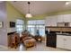 Cozy living room featuring natural light, accent chair and kitchenette at 17816 Se 115Th Ct, Summerfield, FL 34491
