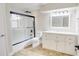 Modern bathroom with glass-enclosed shower, tiled floors, and a bright vanity at 1809 Pineview Cir, Winter Park, FL 32792