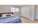 Comfortable bedroom featuring wood floors, closet, and blue and white striped bedspread at 1809 Pineview Cir, Winter Park, FL 32792